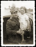 Anna Strzelczyk poses in the arms of her Polish rescuer and adopted father, Tadeusz Strzelczyk, after the war.