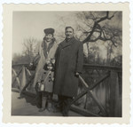A Polish Jewish couple poses on a bridge with their adopted daughter and biological niece.