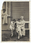 A Lithuanian-Jewish family poses on a wooden bench outside a summer home on the outskirts of Kaunas.