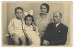 Studio portrait of a Romanian-Jewish family.

Pictured are Shneur, Tirza, Slima and Baruch Engler.