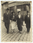 A Romanian Jewish couple walks to the synagogue together with the rabbi and his wife.