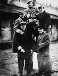 Five Jewish teenage boys pose outside in a pyramid in the Piotrkow Trybunalski ghetto.