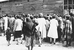 Jewish women and children are gathered outside a wooden barracks in Piotrkow Kujawski.