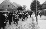 Jewish men are marched through town during a deportation action in Plonsk.