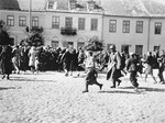Jews are hurrying to a section of the town square in Plonsk where they have been forced to assemble.