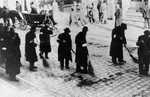 Jews are forced to sweep the street in the Rzeszow ghetto.