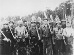 Jews in a forced labor brigade pose holding shovels in the village of Piotrkow Kujawski.