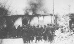 A unit of German soldiers views the burning of a synagogue in Siedlce.