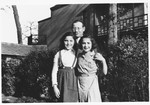 Jonas Tiefenbrunner poses with two girls outside the Mariaburg DP children's home near Antwerp.