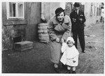 Grete and Eugene Kovacs pose on a street of Galanta together with their one-year-old niece Erika Taubner.