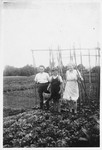 A Jewish child poses with his rescuers in their vegetable garden in Dinant, Belgium.
