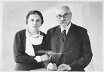 Studio portrait of Miriam Lipert and her father, Chaim Arye Chasan, taken on occasion of her visit from America.