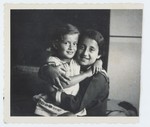 Lida Kleinman hugs an older girl, Ola Weinberger.