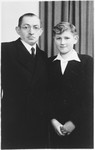 Studio portrait of a Jewish father and son taken on the occasion of the son's bar mitzvah, two years after the liberation.
