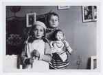 Two young children play with a large doll.

Pictured are Lida Kleinman and Jezek Pepelowier.
