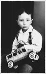 Studio portrait of Laszlo Kovacs (the cousin of the donor) with a toy car.