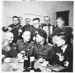A group of SS officers gather together for a celebration [probably in Dachau].