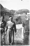 Three members of the Armée Juive walk through a field at their training camp in the Alps.