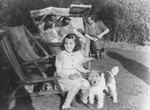 Helga Uszerowicz plays outside with a dog in Nottingham where she came on a Kindertransport.
