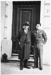 Jewish Brigade soldier Arthur Einhorn poses with his father at the entrance to a building during their first postwar reunion.