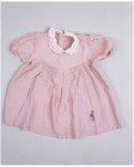 A pink dress with a white "peter pan" collar worn by the donor's sister, Lela, who was killed in a German bombing raid on Sarajevo.