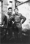 A Jewish Brigade soldier poses in a courtyard in Antwerp, Belgium with one of the members of the Kibbutz Buchenwald hachshara who is waiting for passage to Palestine.