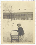 A young Jewish child plays outside in the snow shortly before the creation of the Krakow ghetto.