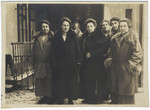 A Czech-Jewish woman poses surrounded by her six grown children outside her home in Nachod.