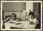 Two young children sit at a table and eat soup.

Pictured on the right is Michal Kraus.