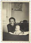 A Jewish mother poses with her newborn daughter inside their home in Krakow prior to the creation of the ghetto.