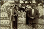 Members of the Kremin family gather by the tombstone of Yehuda Menachem Kremin.
