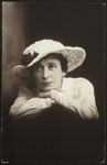 Close-up photograph of a young woman in a hat sent to a friend in Eisiskes with New Year's greetings.
