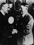 Adolf Hitler greets Neville Chamberlain upon the British Prime Minister's arrival in Munich.