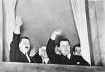 Adolf Hitler, Wilhelm Frick, Hermann Goering and Rudolf Hess greet participants in an SA and Stahlhelm torchlight parade in honor of Hitler's appointment as Chancellor as it passes by the chancellery.