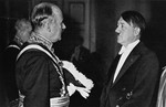 Adolf Hitler converses with French Ambassador Andre Francois-Poncet at a New Year's Eve reception.