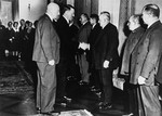 Adolf Hitler greets a group of unidentified dignitaries.