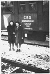 Two teenage Jewish DPs who have joined a children's transport pose outside the train that will take them from Prague to Paris.