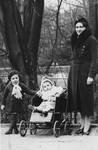 A Jewish mother poses with her two young children in a park in Antwerp, Belgium.
