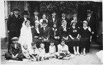 Relatives of the bride and groom pose for a family portrait at a Jewish wedding in Bilki.