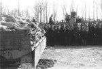 German civilians view a wagon piled high with corpses in the newly liberated Buchenwald concentration camp.