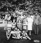 Group portrait of members of three Jewish refugee families in Malo, Italy, where they have been confined by the Italian authorities.