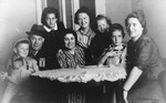 Members of the Deutsch family, some of whom are wearing Jewish badges, pose in their home in Zagreb with an Austrian Jewish refugee family that was living with them.