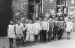Children from the Jewish kindergarten in Kaunas (located at 9 Mapu Street) pose outside their school before leaving on an outing.