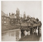Wagons laden with corpses leave the Dachau concentration camp en route to a burial site.