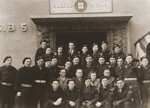 Group portrait of members of the Jewish police force in front of their headquarters at the Bergen-Belsen DP camp.