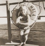 A girl poses in the life preserver on the deck of the Mala immigrant ship.