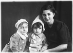 Studio portrait of a Jewish woman with two of her children.