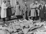 A group of American editors and publishers in Dachau are shown the corpses of prisoners during their investigation of the camp.