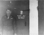 An American soldier stands outside of the gas chamber in Dachau.