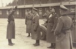 Reichsfuehrer SS Heinrich Himmler is saluted upon his arrival in Dachau for an official visit.